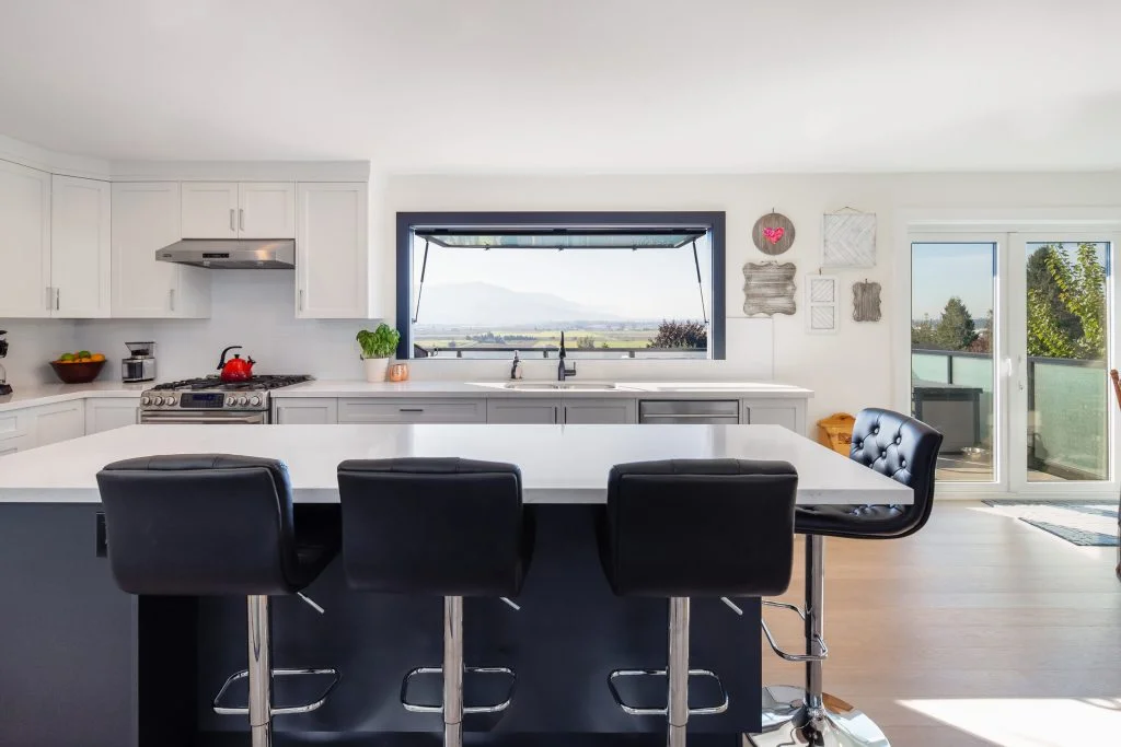 Indoor-outdoor kitchen window for entertaining spaces