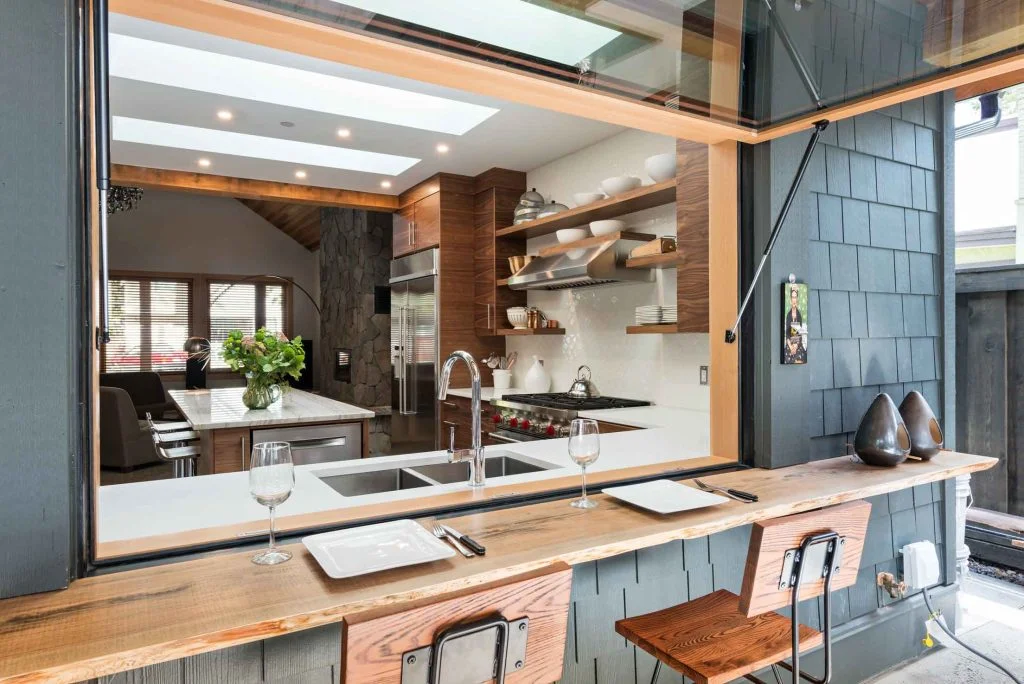 Luxury pass-through window connecting kitchen and patio